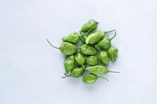 green chili on a white background with copy space .