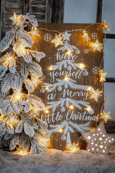 Board with Merry Christmas message on wooden background.