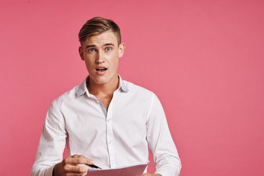 businessmen in a white shirt talking on the phone pink background. High quality photo