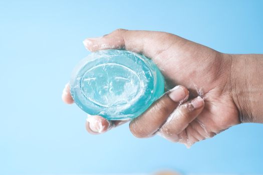 young man washing hands with soap warm water.