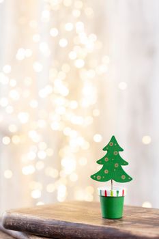 Christmas tree on wooden, bokeh background. Christmas holiday celebration concept. Greeting card.