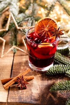 Christmas mulled wine with spices on a wooden rustic table.