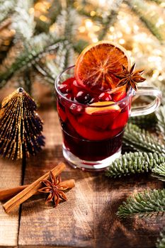 Christmas mulled wine with spices on a wooden rustic table.