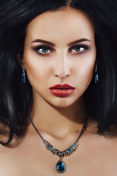 portrait of a brunette girl with red lips and blue eyes