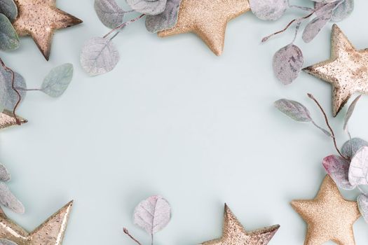 Festive pastel background. Christmas stars and shining glitter, confetti on pastel background. Christmas background, Flat lay.