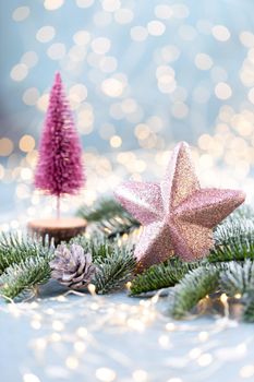 Christmas spruce with star and blurred shiny lights.