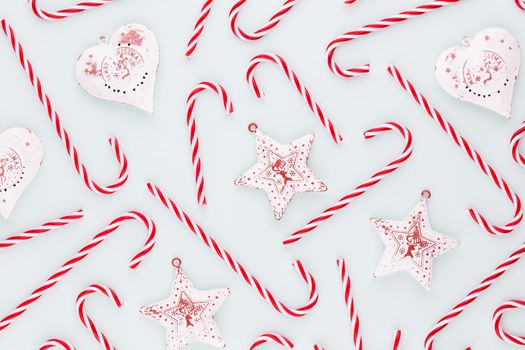 Christmas candy cane lied on blue background. Flat lay and top view.