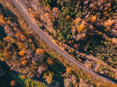 Aerial view of autumn countryside with railway, traditional fall landscape from bird eye. Czech Republic,Vysocina highland, Central Europe