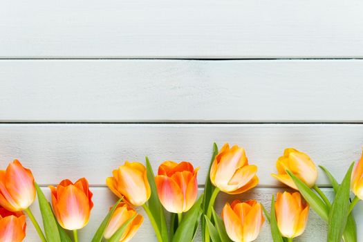 Yellow pastels color flowers on yellow background.Waiting for spring. Happy Easter card. Flat lay, top view. Copy space.