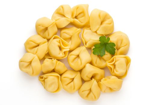 Raw homemade pasta,tortellini with herbs.