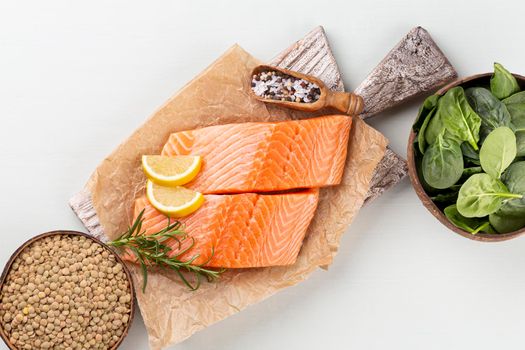 Fresh salmon steak with spinach and lentils.