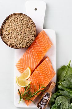 Fresh salmon steak with spinach and lentils.