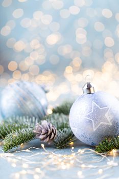 Christmas spruce with ball and blurred shiny lights.