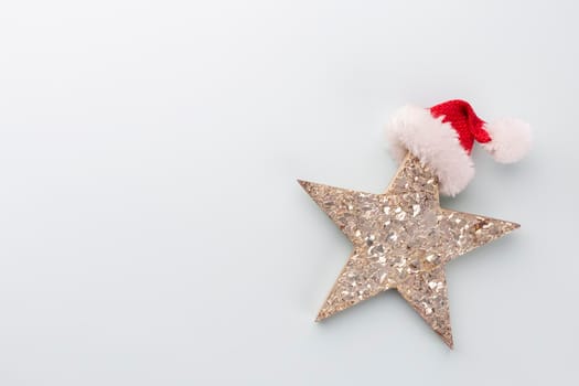 Christmas star and santa hat, decor on pastel blue background. 