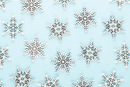 Christmas background. White snow decorations on a pink background.