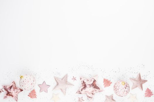 Christmas minimalistic and simple composition in pink color. Christmas star, decorations on white background. Flat lay, top view with copy space