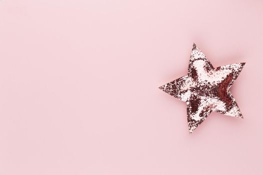 Christmas star, decor on pastel colored background. Christmas or New Year minimal concept.