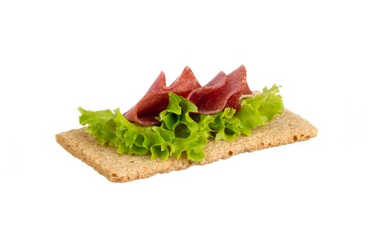 Variety of mini sandwiches with cream cheese, vegetables and salami. 