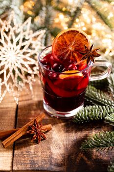 Christmas mulled wine with spices on a wooden rustic table.