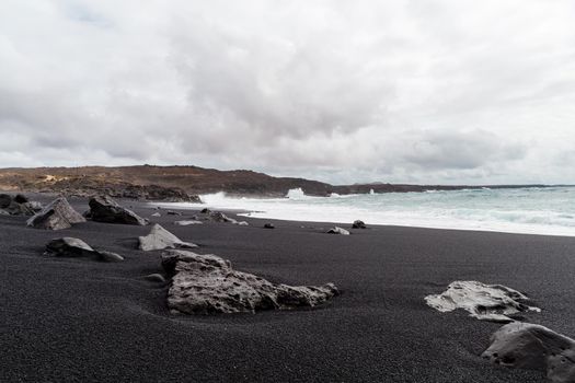 Beautiful beach on the island of Lanzarote. Sandy beach surrounded by volcanic mountains / Atlantic Ocean and wonderful beach. Lanzarote. Canary Islands 