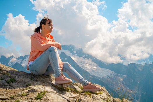 Female traveler enjoying beautiful view in mountainous area.