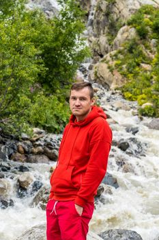 Adult male tourist enjoying beautiful view in mountainous area.