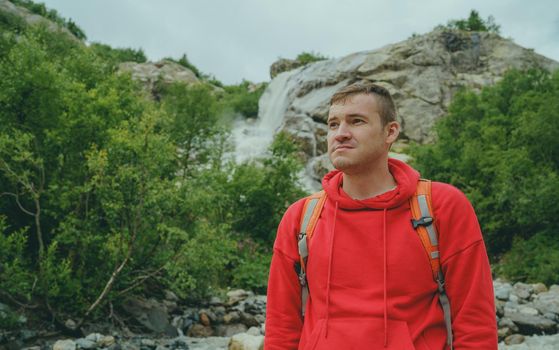 Adult male tourist enjoying beautiful view in mountainous area.