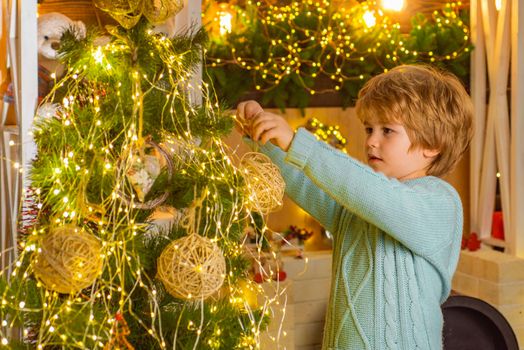 The morning before Christmas. Cute little kids celebrating Christmas. Portrait of Santa kid with bauble looking at camera. Happy new year. Christmas decorations