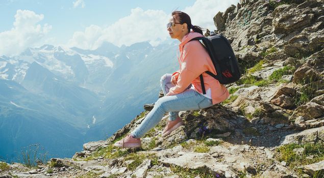 Female traveler enjoying beautiful view in mountainous area.