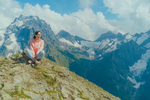 Female traveler enjoying beautiful view in mountainous area.