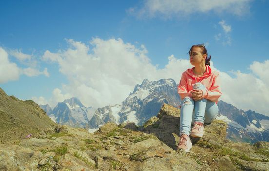 Female traveler enjoying beautiful view in mountainous area.