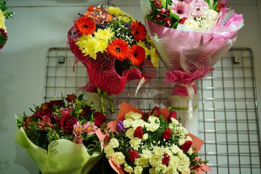 Bouquets of various flowers on counter. Fresh beautiful flowers in florist shop