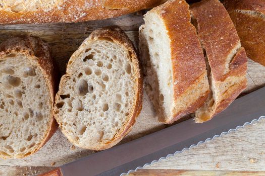 piece of whole grain bread in gray, baguette cut into pieces, closeup on a counter in the kitchen