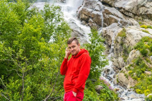 Adult male tourist enjoying beautiful view in mountainous area.