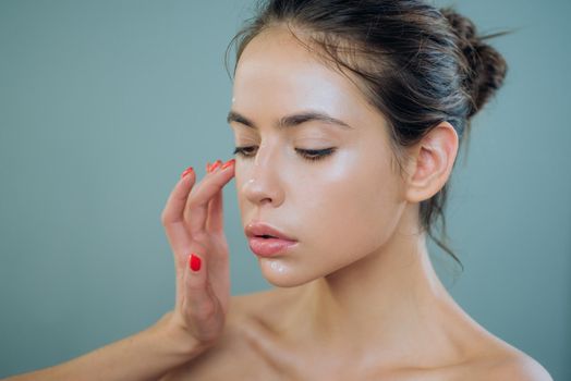 Professional makeup artist, visagist and stylist work. Customer service in beauty salon concept. Pretty young woman model is getting her natural nude makeup done