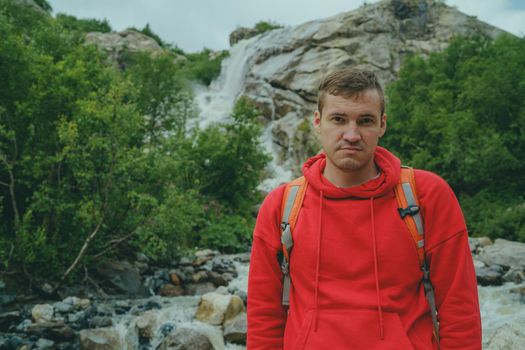 Adult male tourist enjoying beautiful view in mountainous area.