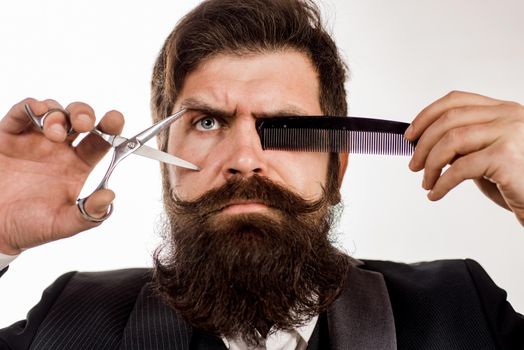 Bearded man with long moustache. Man in barbershop. Handsome bearded man with long beard moustache and brunette hair on white background. Brutal hipster in barbershop