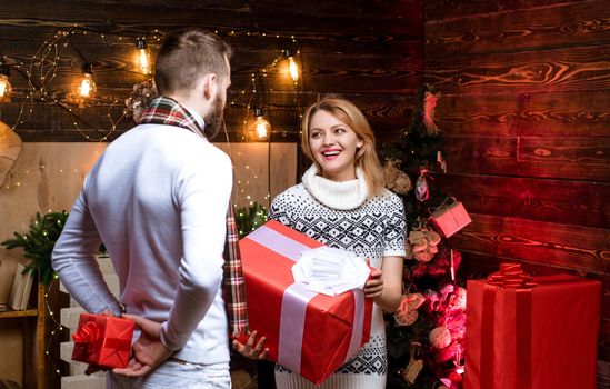 Man handsome with gift box surprise for girlfriend. Man hipster give gift to girl christmas decorations background. Surprise for sweetheart. Merry christmas and happy new year. Christmas gifts.