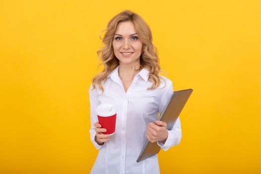 Happy woman teacher with laptop hold takeaway paper cup yellow background, coffee break.