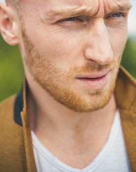 Man with serious face and brutal style. Close up portrait of severe hot guy. Barbershop advertising. Short beard. Portrait of serious young man. Bearded man