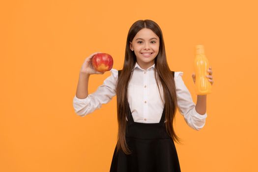 happy school child in uniform hold apple and water bottle, vitamin.