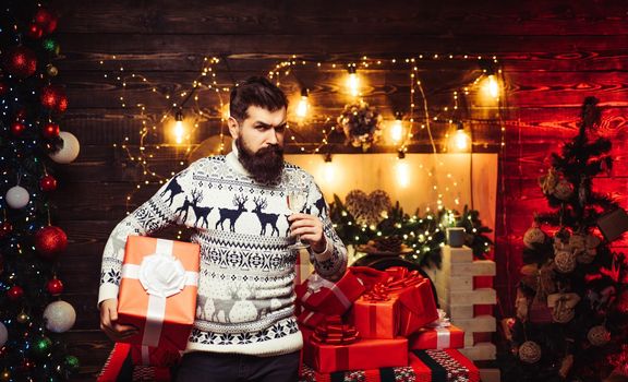 New year concept. Bearded man in Christmas sweater. Happy new year. Bad santa claus in santa hat. New year gift. Man new years eve