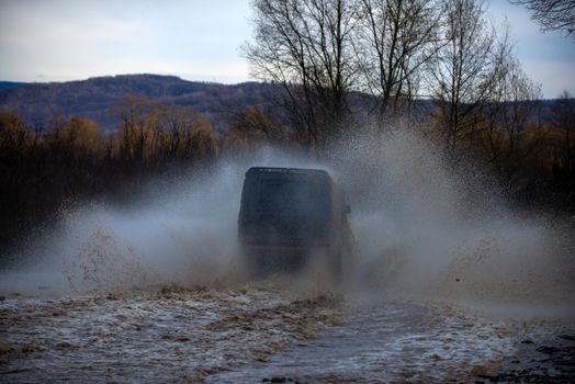 Motion the wheels tires and off-road. Track on mud. Travel concept with big 4x4 car. Tracks on a muddy field. Off-road vehicle goes on mountain way. Jeep outdoors adventures. Off-road 4x4 concept. Extreme