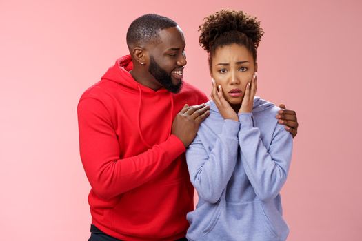 Boyfriend comforting worried nervous girlfriend attend dentist frowning touching face anxiously panicking man hugging girl touch shoulders smiling encourage, look supportive assuring all okay.