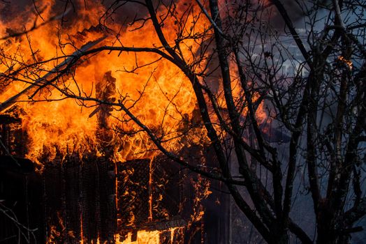 A house on fire and burning down. Totally engulfed. Fire in the house. House fire in the night. Single family detached home completely destroyed