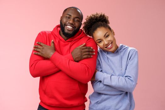 Charming happy sincere african-american family guy girl relationship embracing cross arms chest hugging each other girlfriend lean boyfriend shoulder lovely couply smiling feel love warmth.