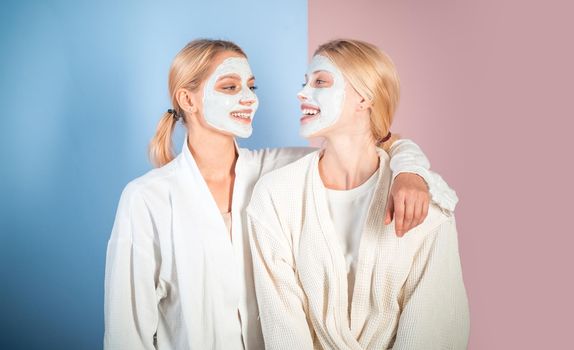 Young women enjoying of facial mask treatment and have a good time with spa procedures. Health and beauty concept. Best friends doing spa procedures and having fun