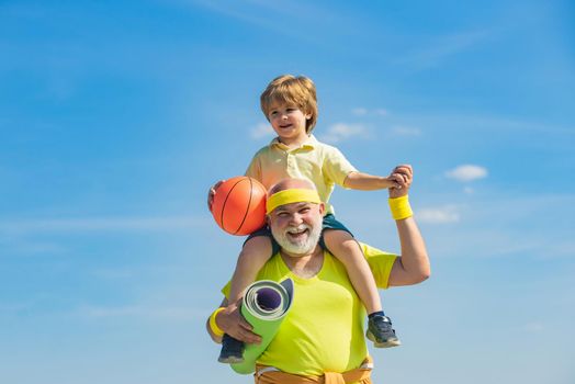 Grandpa and grandson spotting. Father and child training together. I love sport. Active family enjoy sport and fitness. Happy loving family