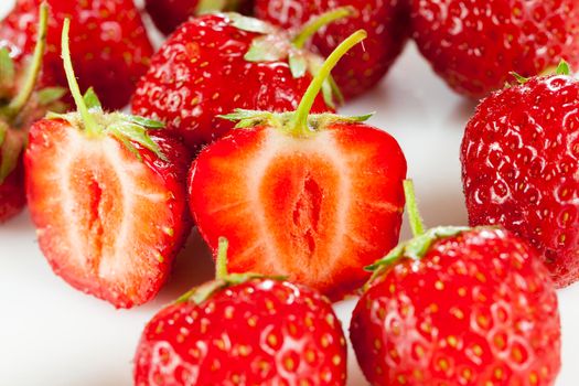 whole and torn berries of strawberries during cooking in the summer of the year, closeup