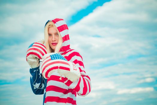 Happy woman with boxing glove with USA flag print. Independence Day concept. American female boxer with boxing glove